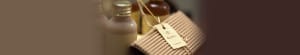 Picture of bronze bottles with wrinkled cardboard wrapped with a paper lace.